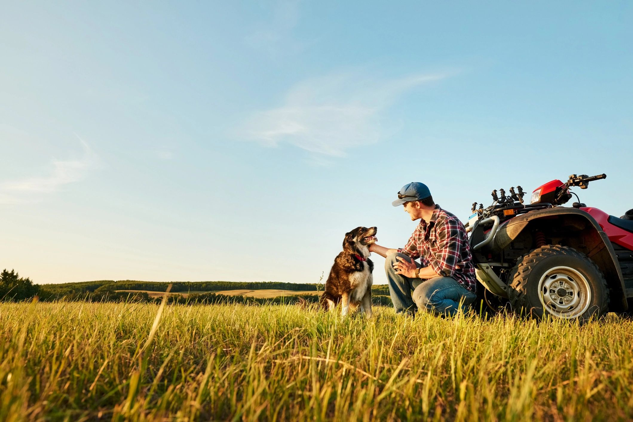 Doberman with handler in an outdoor setting